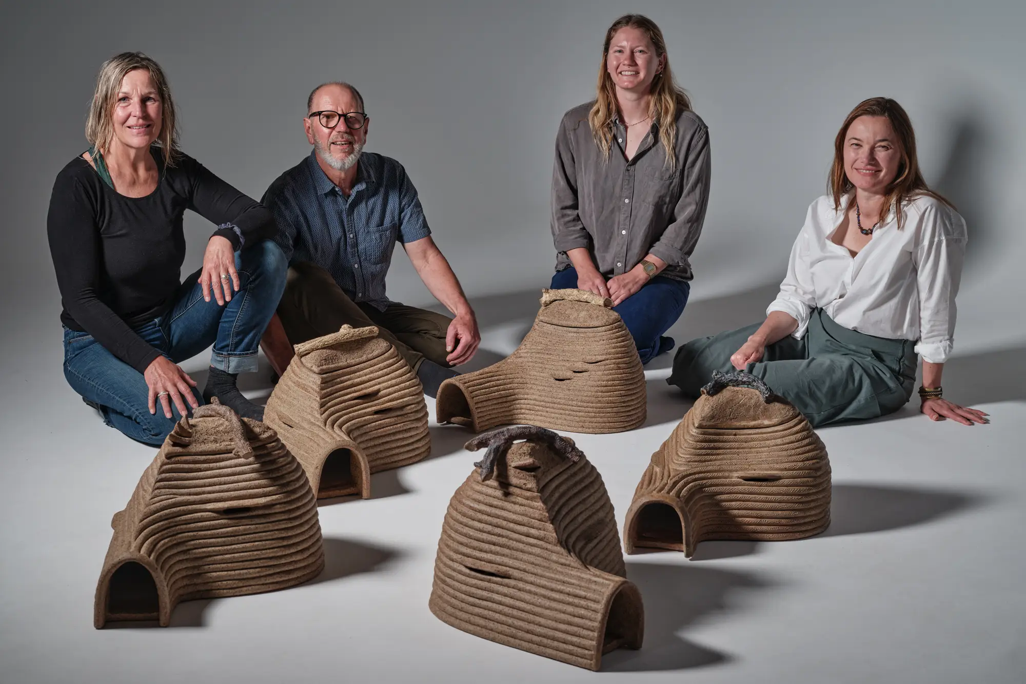 Ceramic art burrows for Hobart Little Penguins project team, with five new ceramic burrows created by Jane Bamford. From left to right: Jane Bamford, Peter Whyte, Ellie Green, Katherine Johnson. Photo: Peter Whyte.