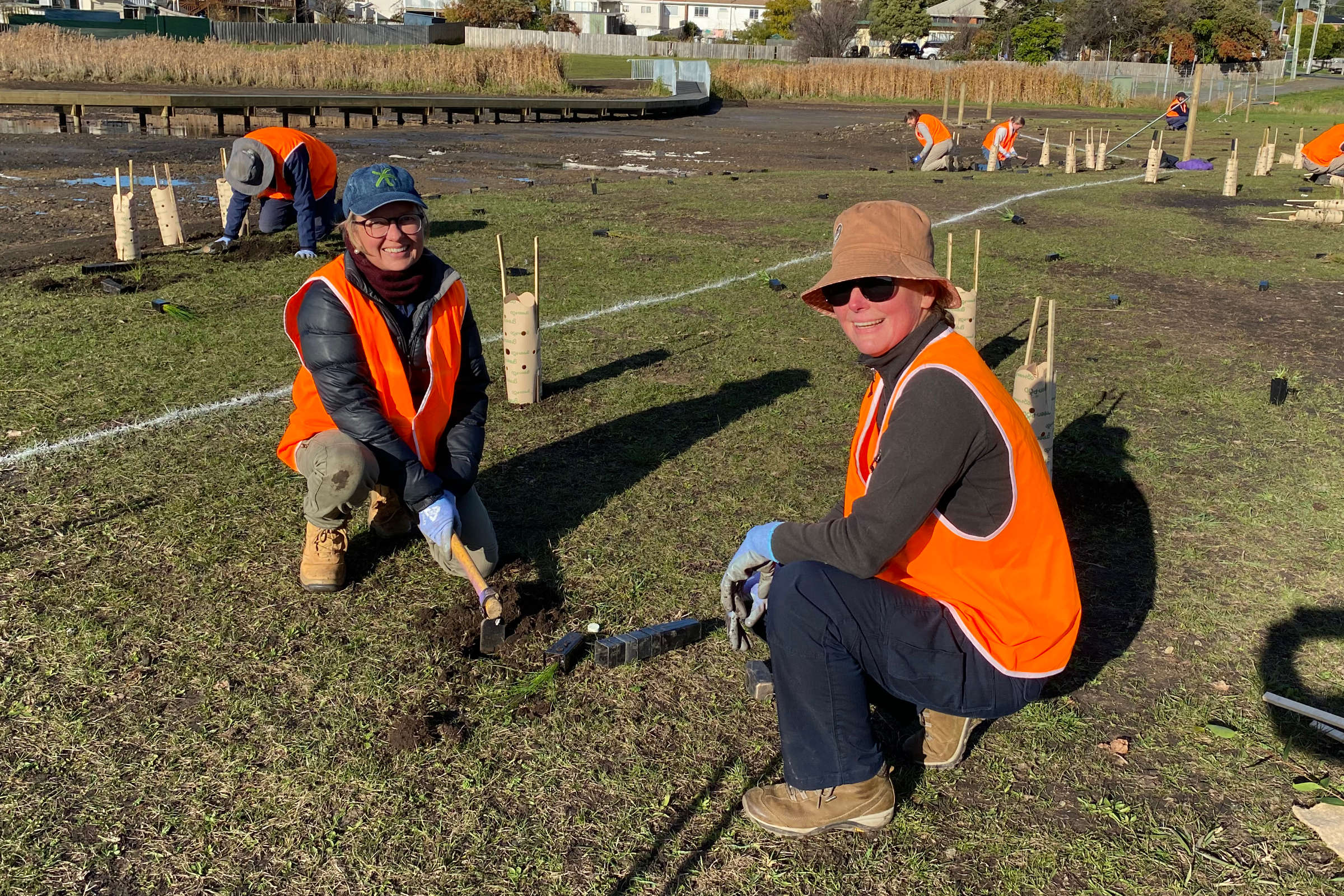 Ursula Taylor and Bec Sheldon planting native vegetation at Windermere Bay. Photo: Danielle Hardie, NRE Tasmania.